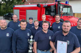 Gruppenfoto mit Pokal und Urkunde